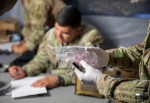 Combat Medic preparing medication in Sick Call