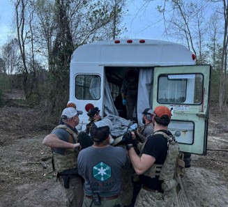 Non Medic Special Operations Forces Austere Medical Technicians perform a patinet handover to a critical care evacuation bus during the RES SOAMT course Photo Credit Paul Loos 2023